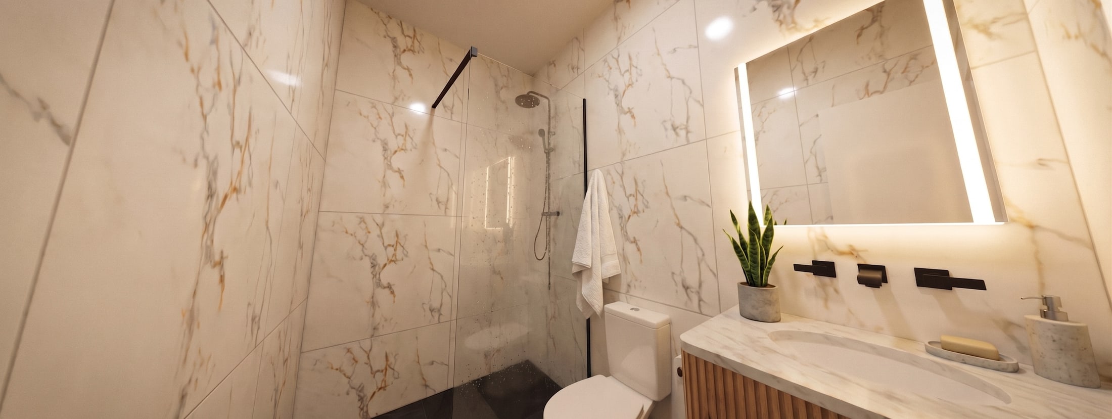 Render de un baño: ducha con mampara de vidrio, revestimiento de gran formato símil mármol, mesón con bacha integrada, espejo con luz perimetral y grifería negra empotrada.